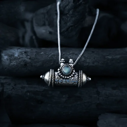 Exquisite handcrafted tribal locket necklace, featuring intricate silverwork and a mesmerizing gemstone centerpiece