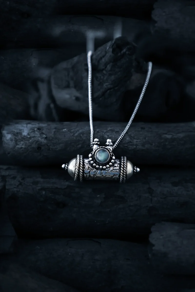 Exquisite handcrafted tribal locket necklace, featuring intricate silverwork and a mesmerizing gemstone centerpiece