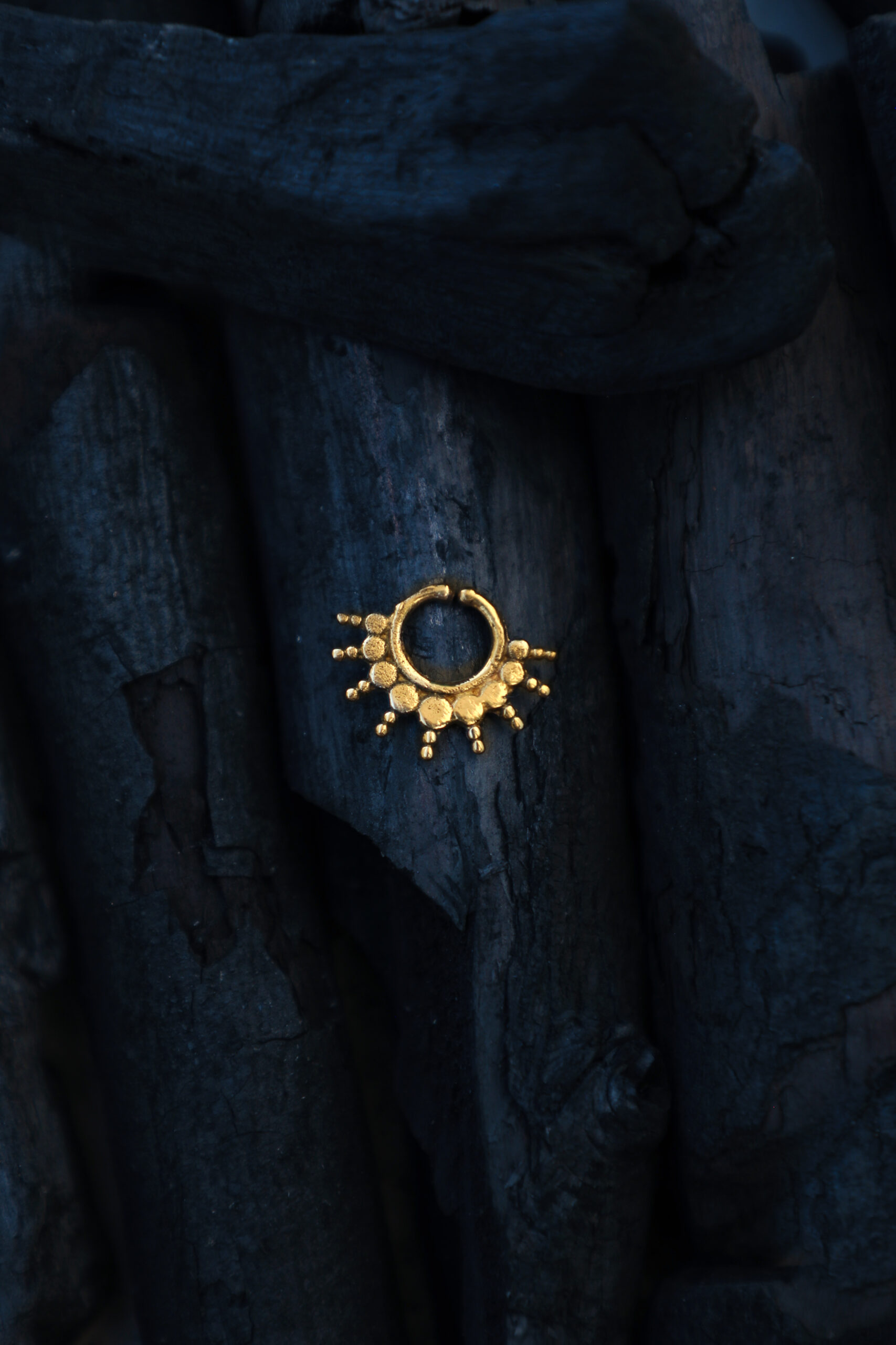 Handcrafted brass septum ring from TribalDesert, featuring a radiant sunburst design inspired by ancient tribal motifs
